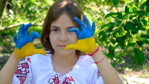 The Ukrainian Flag is Drawn on the Child Hands