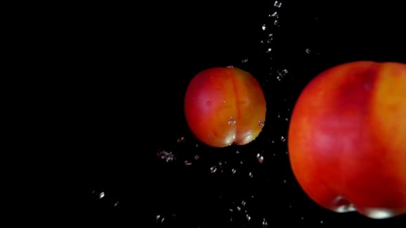 Two Peaches Collide and Rotate Splashing Water