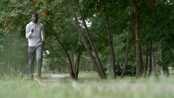 African Man Jogging in Park