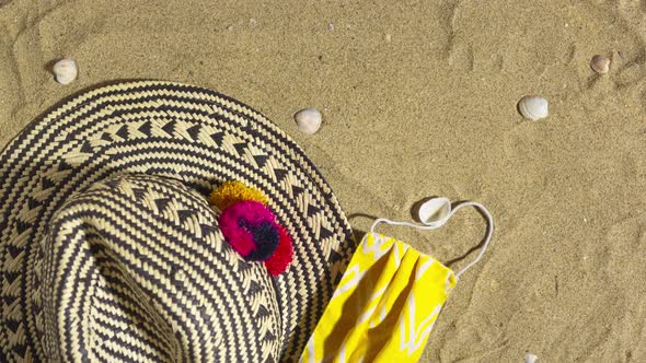 Stop Motion Animation with Hat Sunscreen Protective Mask and Hand Sanitizer on the Sand Background