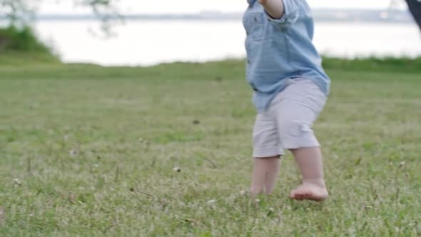 Cute Toddler Boy Walking to Happy Mother