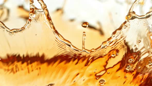 Super Slow Motion Shot of Brown Liquid Splash Isolated on White Background at 1000Fps