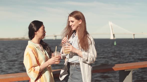 Attractive Women Chatting on Waterfront