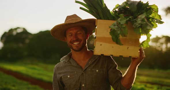 Portrait of farmer holding his harvest