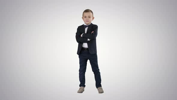 Handsome Child Looking at Camera and Crossing Hands on Gradient Background