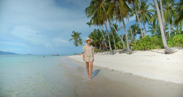 Front Shot of Woman  She Has Vocation Outdoor Walks on Empty Tropical Beach During Sunset Time