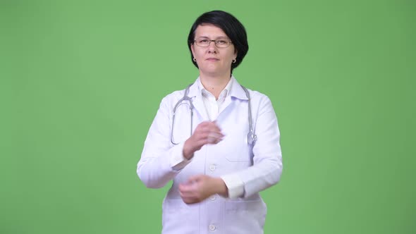 Beautiful Woman Doctor with Short Hair Crossing Arms