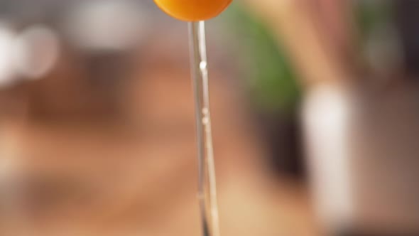 Camera follows adding eggs into bread crumb in a bowl. Slow Motion.