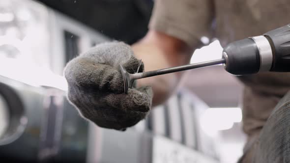 Mechanic in Car Service Polishes and Cleans Engine Valves By Hand