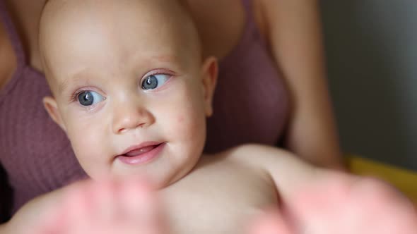 Portrait Funny Blue Eyes Baby Infant Sitting Mother Knees Playing Feet Smiling