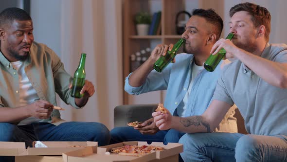 Male Friends Drinking Beer and Watching Tv at Home