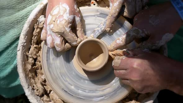 Top View on Potter's Hands Work with Clay on a Potter's Wheel