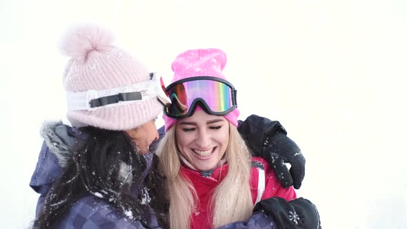 Two Gorgeous Laughing Young Woman at Ski Resort