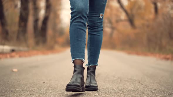 Woman Legs In Leather Shoes Walking On Vacation Holiday In Cold Autumn Day. Woman Resting Walk.