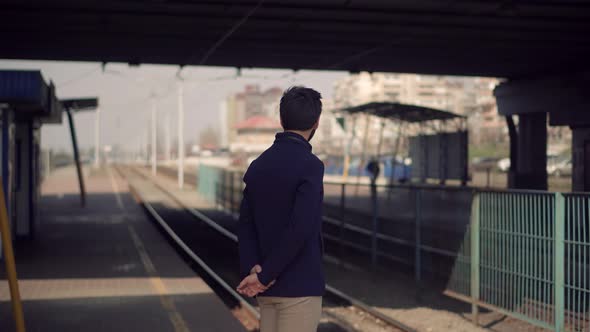 Businessman Hurries To Work And Standing On Railway Train Station Platform. City Tourist Concept.