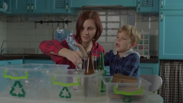 30s Mother and Son Sorting Recycle Waste at Home