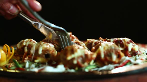 Close-Up Roasted Chicken BBQ With Male Hand Knife Cutting Black Background.