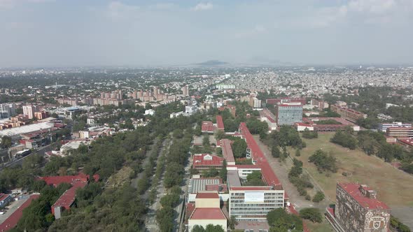 Backwards view of UNAM with drone in mexico city