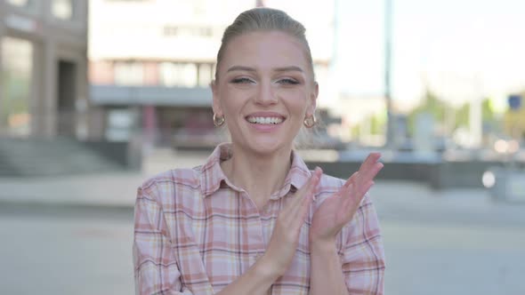 Young Woman Clapping in Appreciation Outdoor