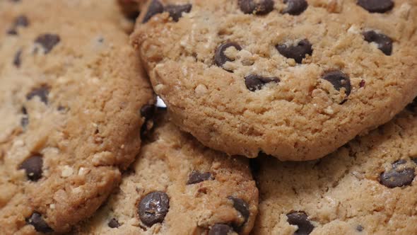 Pile of chocolate chip cakes close-up tilting 4K 2160p 30fps UltraHD video - Biscuit cookies with pi