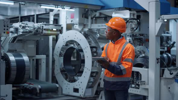 Afro American Engineer Analyzing Data Industrial Factory Work on Modern Facility