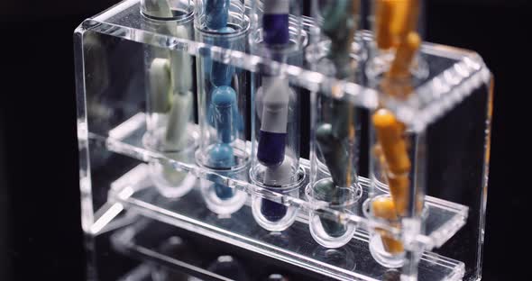 Test Tubes Filled with Pills and Drugs alt