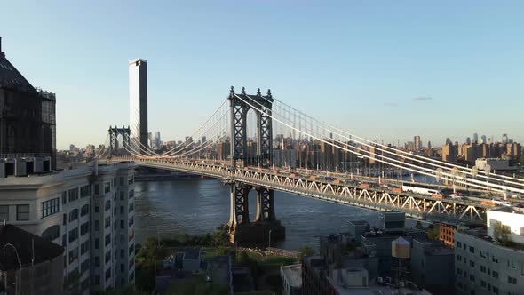 Aerial straight flying drone shot of the Brooklyn bridge located in Brooklyn New York during sunset,