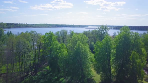 Revealing aerial view of a Lake Usma (Latvia) on a sunny summer day, distant islands with lush green