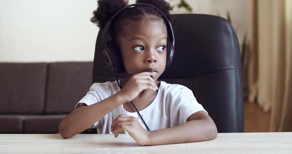 View From Webcam Little Cute Girl Child African American Kid Wears Headphones Speaks Into Microphone