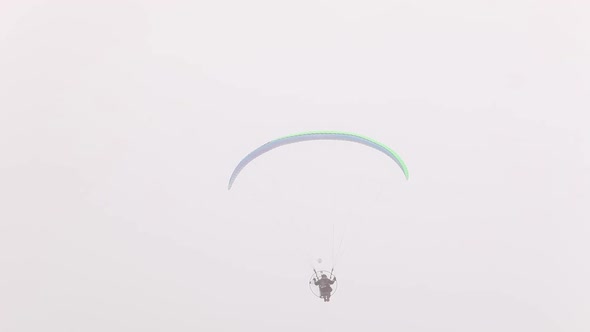 Paraglider Flying in the Sky in Fog Paragliding