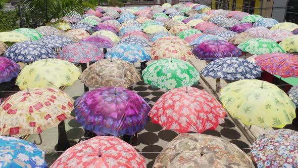 Aerial Footage of the Tourists Hiding in Shade Under Colorful Umbrellas