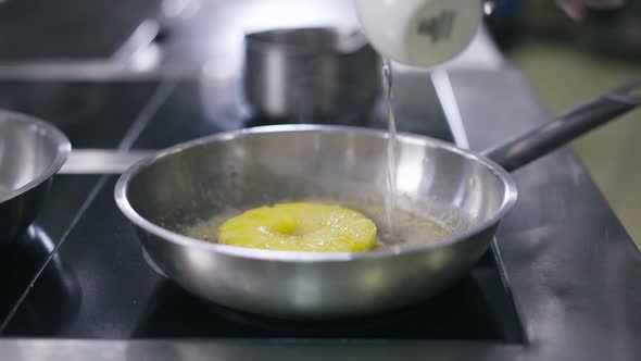 Closeup Unrecognizable Cook Pouring Water in Pan Frying Pineapple in Slow Motion