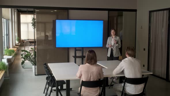 Diverse office conference room meeting: female project manager uses Chroma Key wall mounted