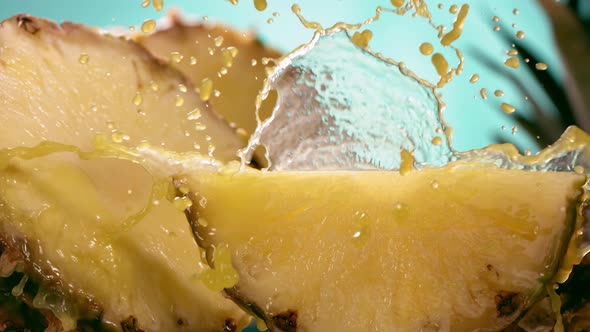 Slow Motion Shot of Pineapple and Juice Splashing Through Pineapple Slices