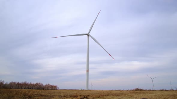 Working wind turbines in field, environmentally friendly renewable energy.