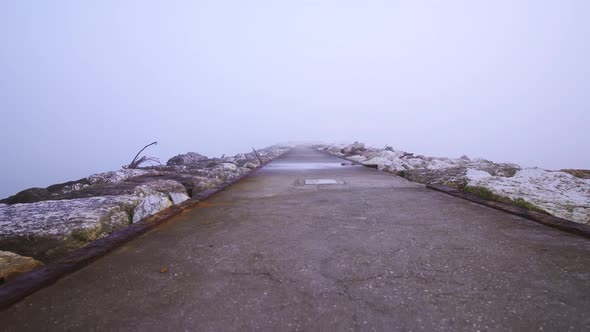 Dike on the Sea in the Middle of the Fog