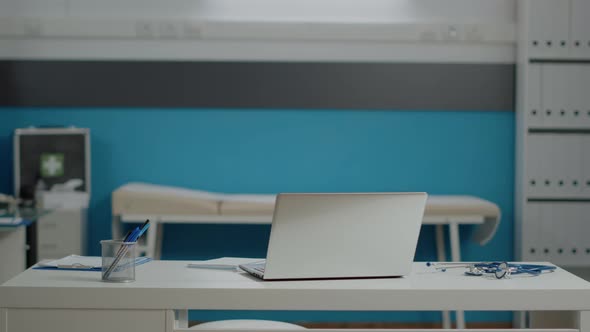 Close Up of White Desk with Laptop and Medical Instruments