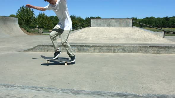 Skateboarder does flip trick, slow motion