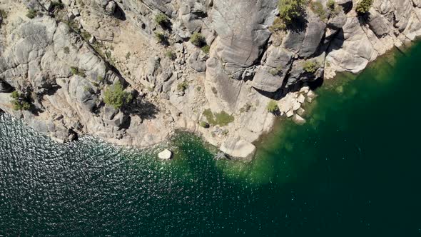 Top down aerial shot of a blue lake in the high Sierras of California.