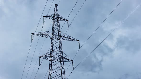 High-voltage power lines on sky background