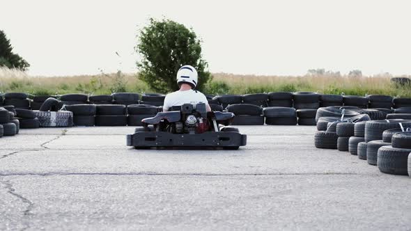 Male Racer in Protective Helmet Racing on the Go-kart Track Outdoors