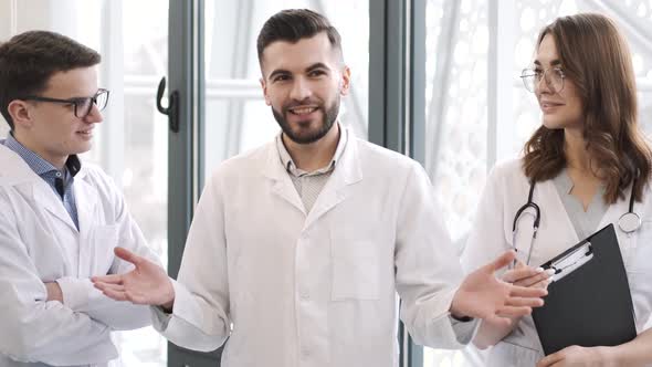 Three Medical Workers Having a Conversation at Clinic