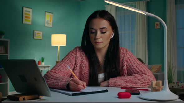 Young Woman Student Is Studying at Home