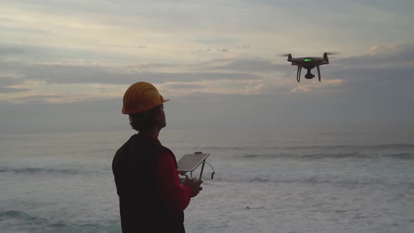 Male engineer doing inspection using drone - Technology and industrial concept