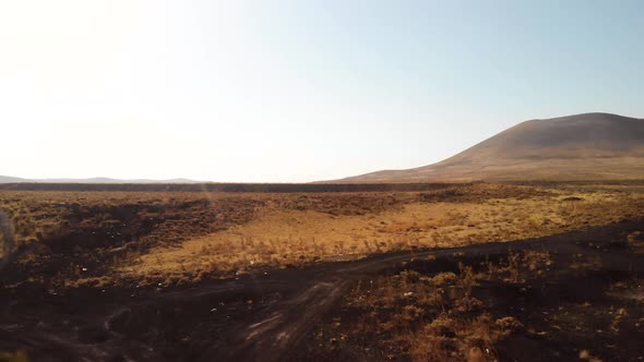 Mars Rover Robot Moving on a Road to Volcano on Red Planet