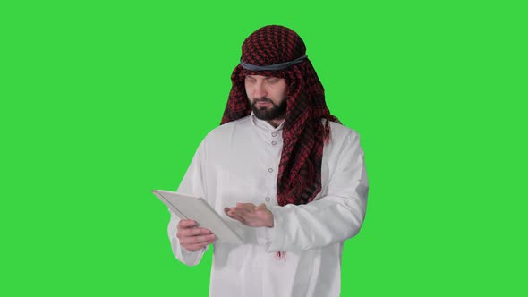 Sheikh Using Digital Tablet and Walking on a Green Screen, Chroma Key.