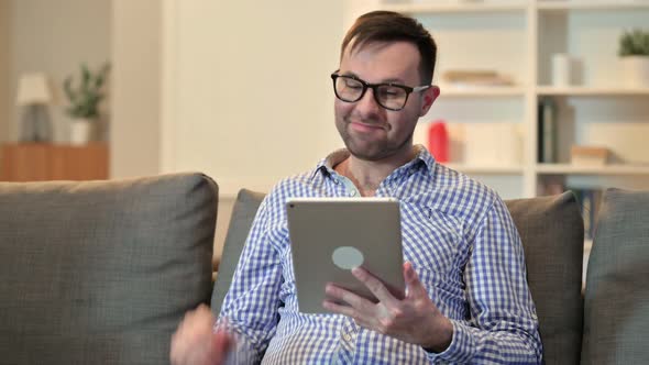 Online Video Chat on Tablet By Young Man at Home 