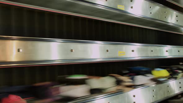 People Zoom Past On Escalators