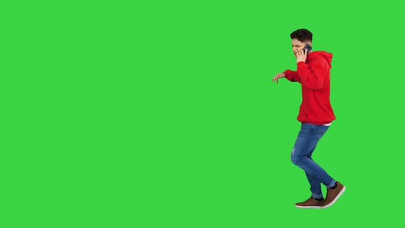 Casual Hip-hop Man Walking and Talking on the Phone and Dancing on a Green Screen, Chroma Key.