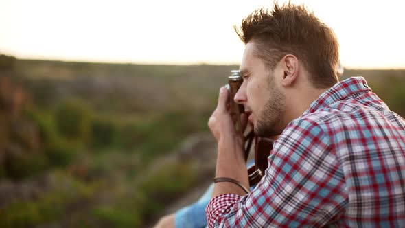 Young Handsome Male Making Photo with Camera